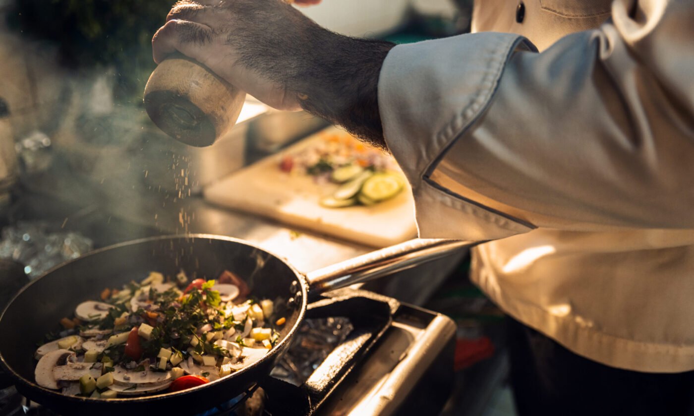 Chef cooking in a restaurant kitchen.